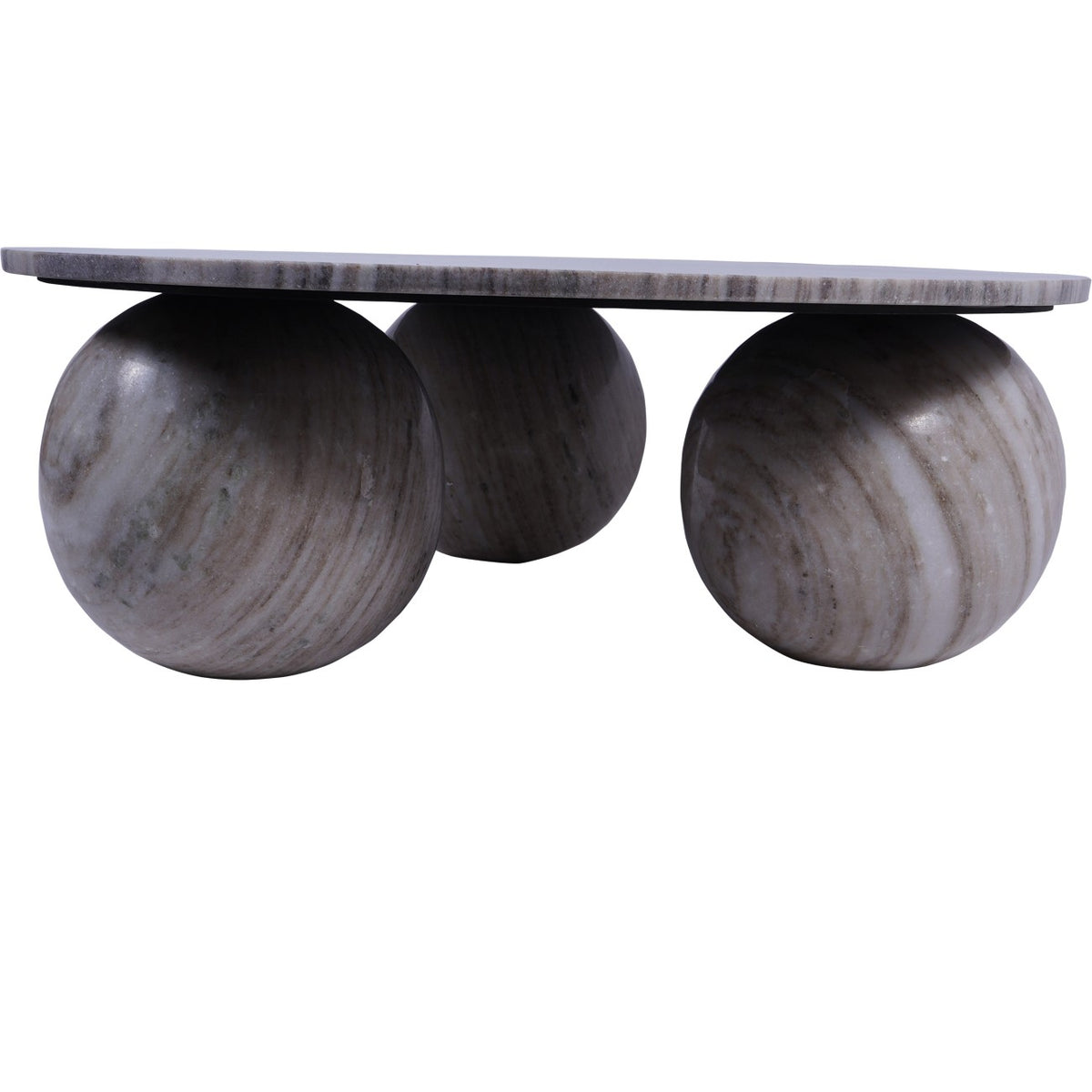 Low side view of the coffee table showing its slim marble top above three large spherical feet.