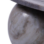 Detail of a polished spherical marble foot showing pale grey and brown markings beneath the tabletop.