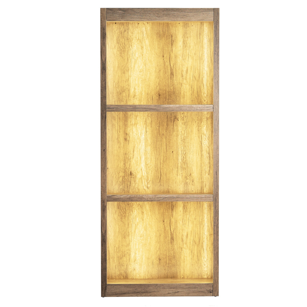 Front view of the three-bay shelving unit photographed with a golden glow across the back panels.