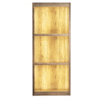 Front view of the three-bay shelving unit photographed with a golden glow across the back panels.