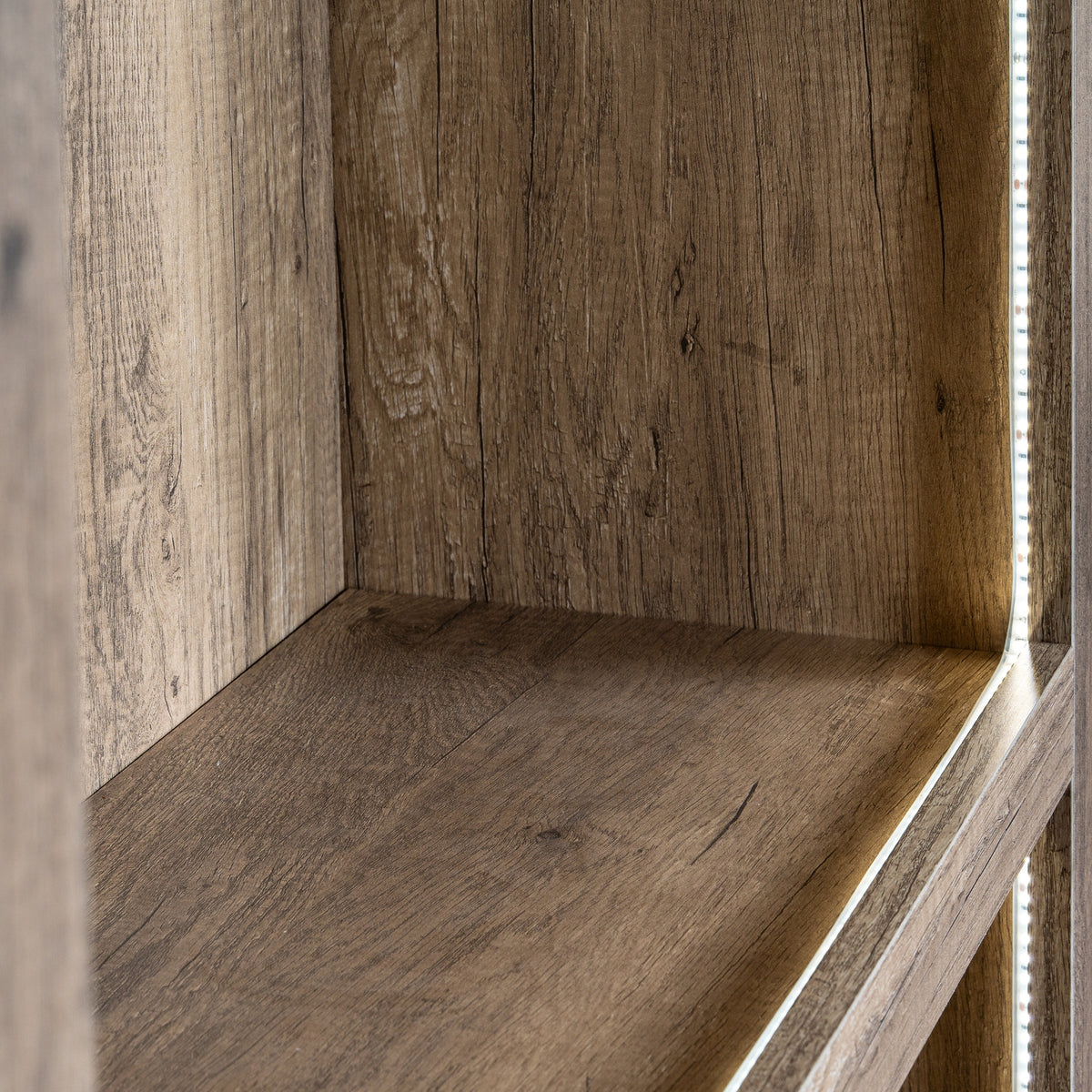 Close-up inside a shelf bay, showing the brown grain pattern and a bright vertical strip beside the right edge.