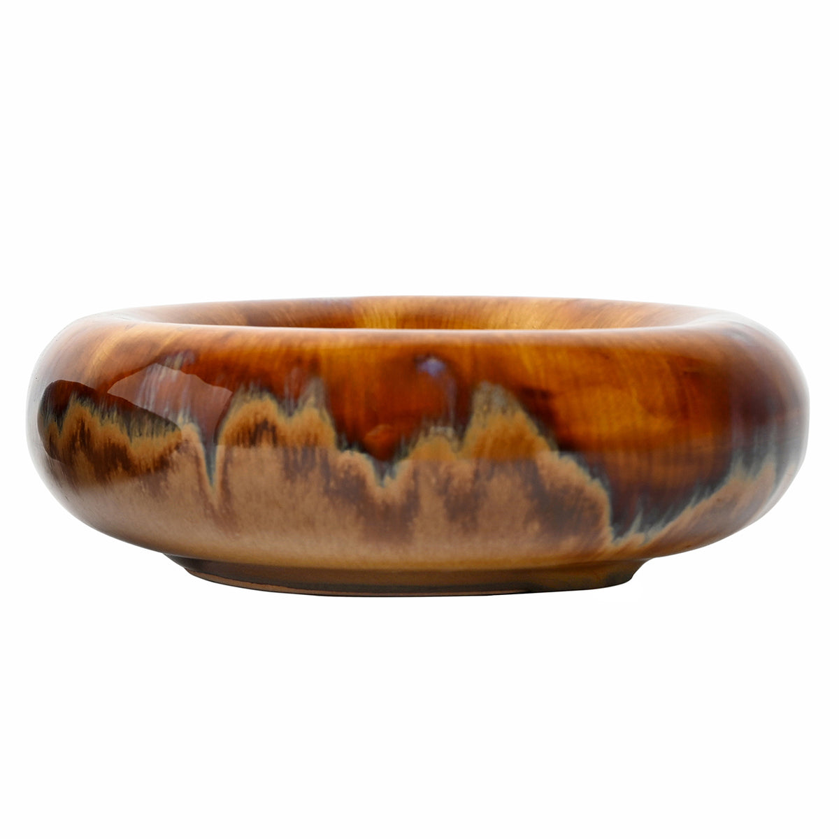 Front view of Tide bowl showing its low rounded profile, glossy amber and brown glaze, charcoal patches and recessed foot.