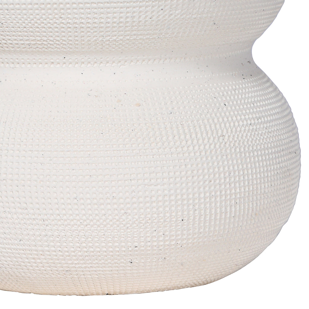 Detail of the white vase's textured lower curve and smoother band between rounded sections.