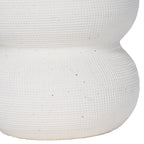 Detail of the vase's closely patterned white surface and narrow join between two rounded sections.