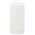 White cylindrical LED candle viewed slightly from above, showing its rounded upper edge, recessed top and three unlit white flame-shaped elements.