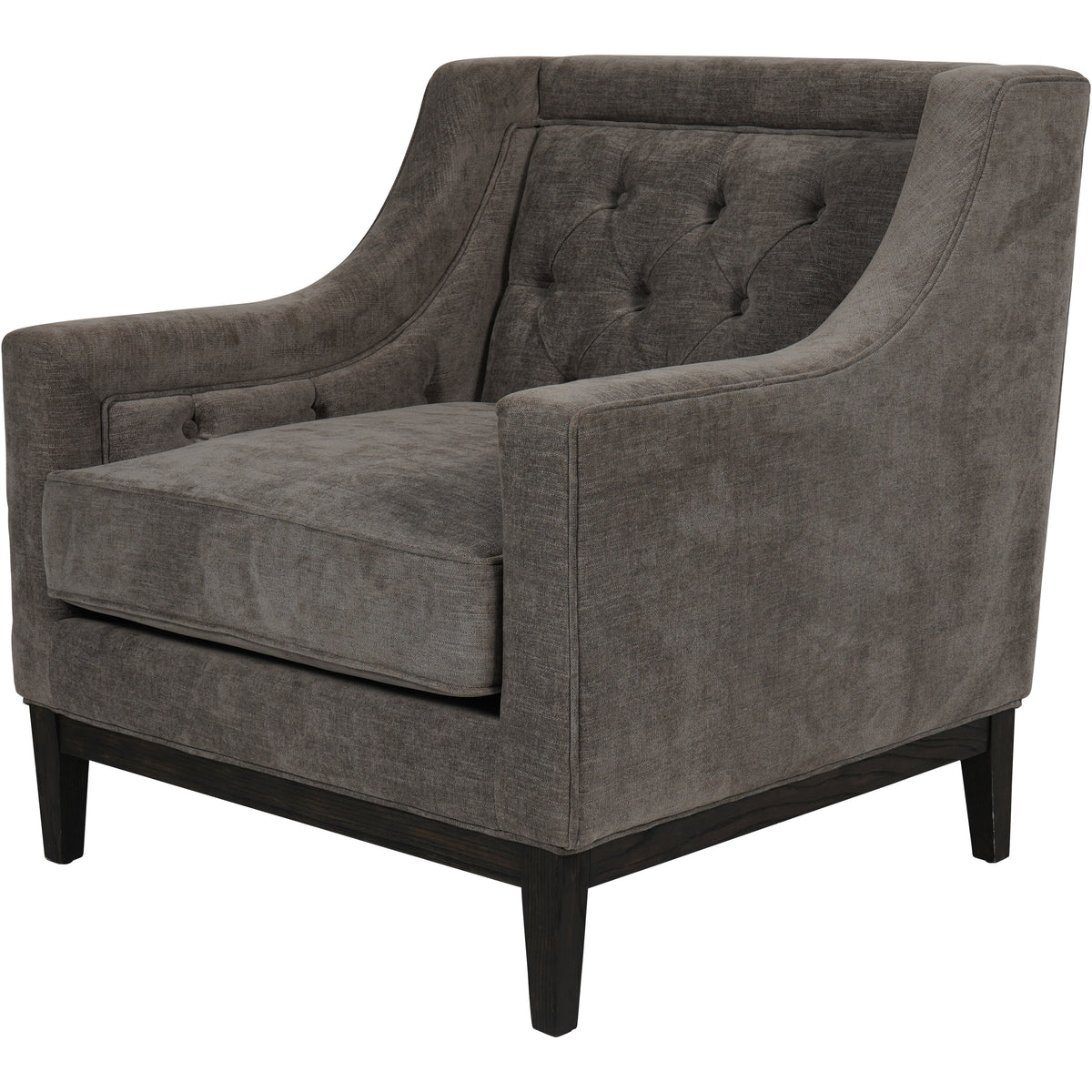 Three-quarter view showing the armchair’s swept arms, piped upholstery, buttoned inner back and exposed dark wooden base.