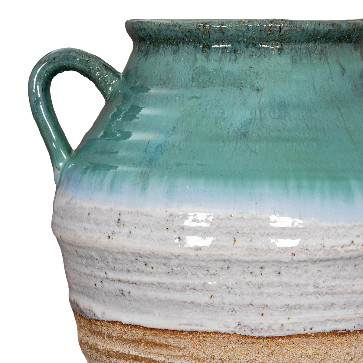 Detail of the left handle and rounded vase shoulder, with glossy turquoise-green colour above pale horizontal ridges.