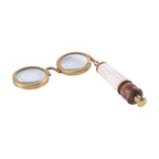Magnifier lying diagonally on a white background, showing the depth of the twin lens frames and the shaped wooden handle end.