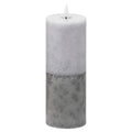 Tall cylindrical LED candle with pale grey-white mottling above a darker grey base and a white flame-shaped element, against a white background.