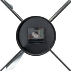 Rear close-up of the clock's black central disc, with a movement marked QUARTZ and an empty battery compartment between diagonal braces.