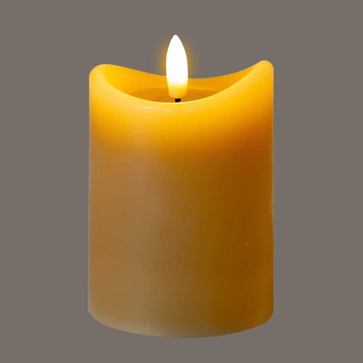 Taupe LED candle photographed with a bright white flame-shaped element and an amber glow around its dipped rim against a grey background.