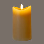 Taupe LED candle pictured illuminated against a grey background, with a bright white flame-shaped detail and amber colour around the dipped rim.
