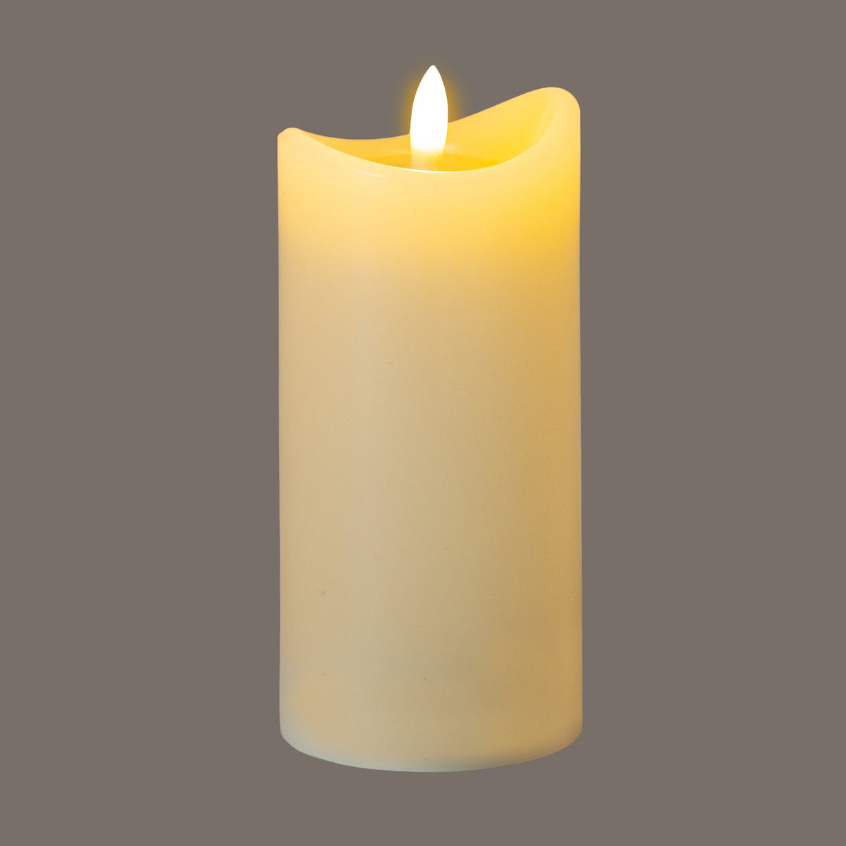 Cream LED pillar candle pictured illuminated against a grey background, with a bright flame-shaped detail and yellow light around the dipped rim.