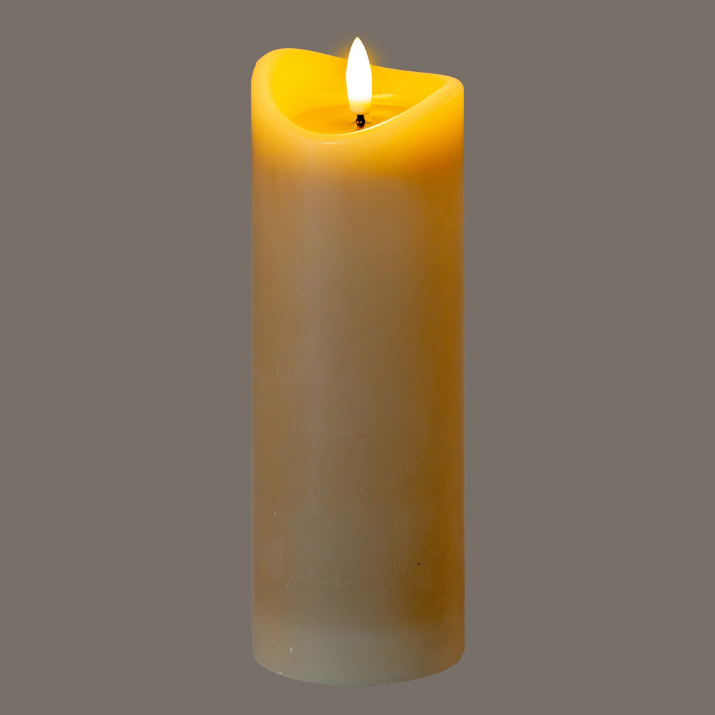 Taupe LED candle pictured illuminated against a grey background, with a bright flame-shaped element and golden light around the recessed top and uneven rim.