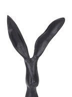 Close-up of the hare sculpture's head and two long ears, showing the textured black surface.