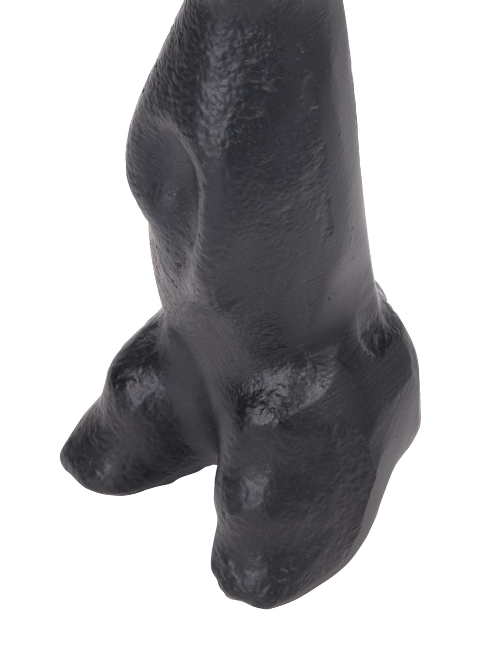Close-up of the hare sculpture's lower body and hind feet, with light catching the textured black surface.