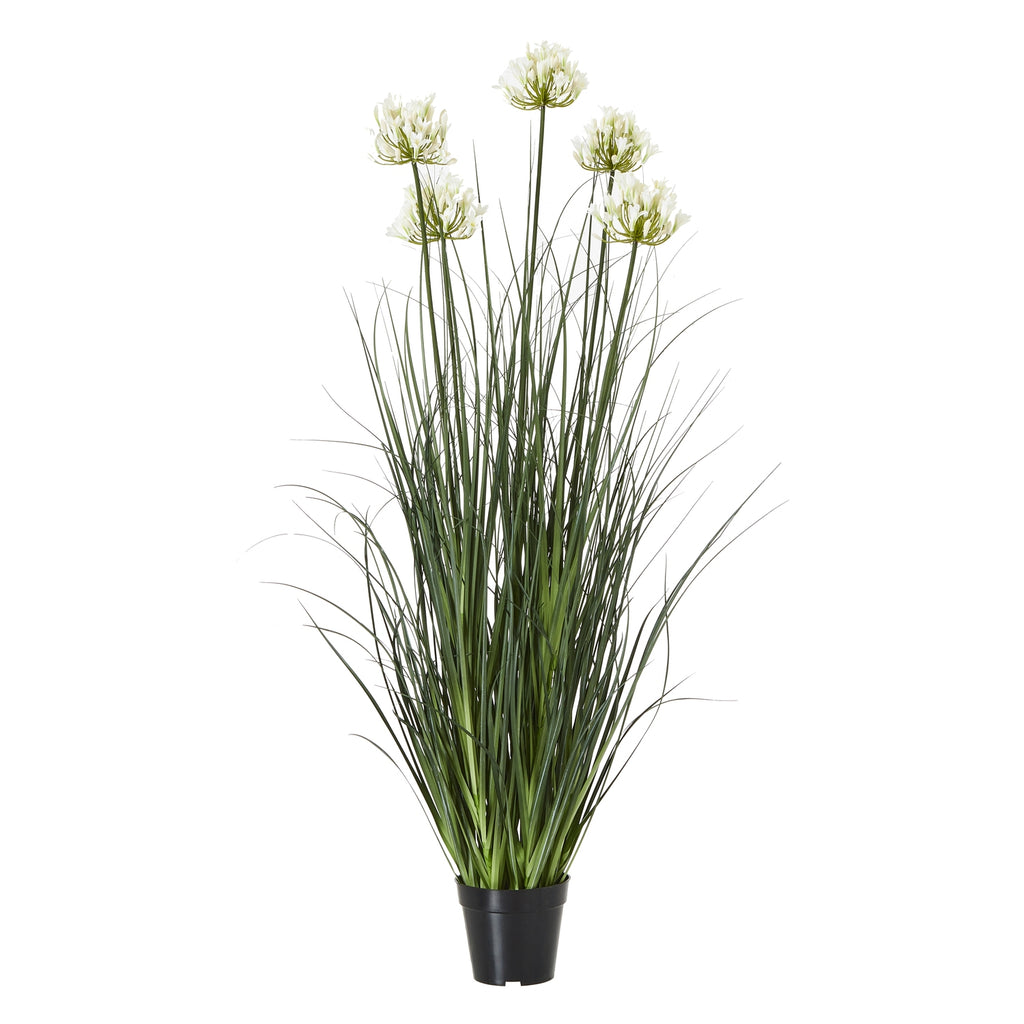 Full view of the artificial arrangement with cream-white flower clusters at varied heights above tall green foliage and a tapered black pot.