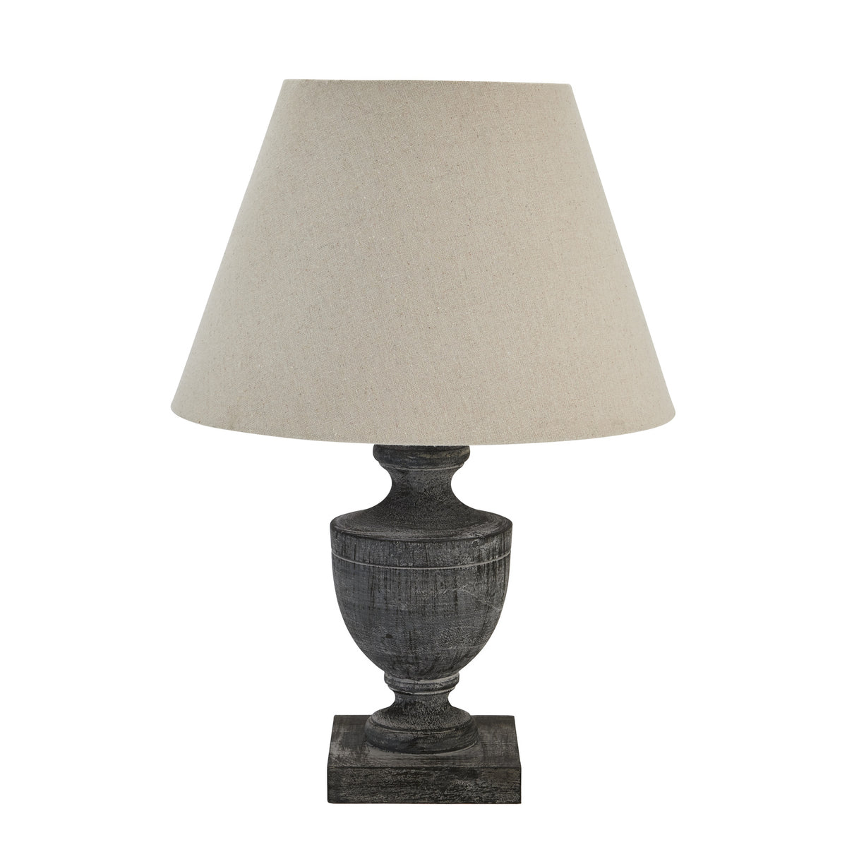 Urn Plinth Table Lamp with a pale tapered shade and dark grey-washed urn base on a square plinth, against white.