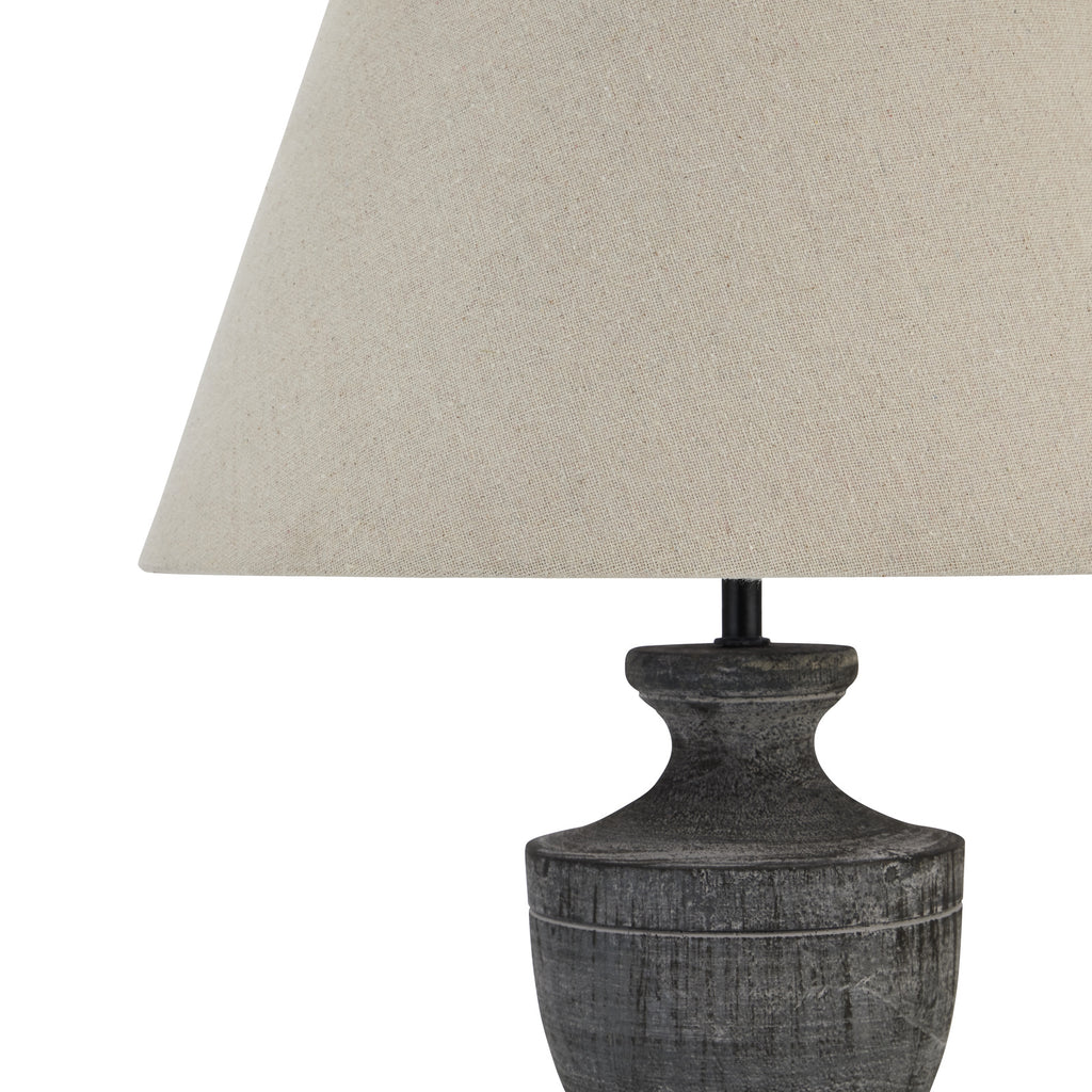 Close view of the pale shade's fine woven texture above the grey-washed neck and rounded shoulder of the lamp base.