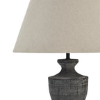 Close view of the pale shade's fine woven texture above the grey-washed neck and rounded shoulder of the lamp base.