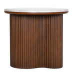 Front view of a round side table with a pale marble top and a brown fluted pedestal curving inwards at the centre.