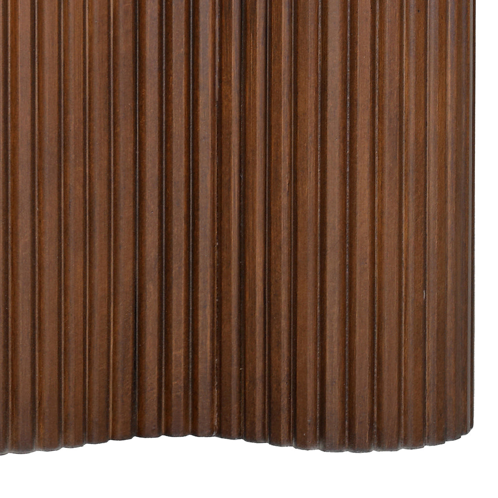 Close-up of deep vertical fluting following the brown pedestal's inward and outward curves at the lower edge.