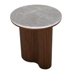 Elevated angled view showing the grey veined marble surface and the curved shape of the fluted brown pedestal.