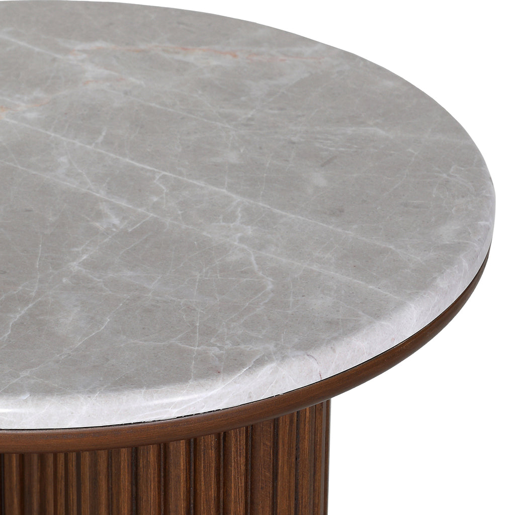 Close-up of fine veining in the grey marble top, its rounded edge and the brown wood rim beneath.