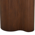 Close-up of the brown pedestal's vertical fluting and inward curve along its lower edge.