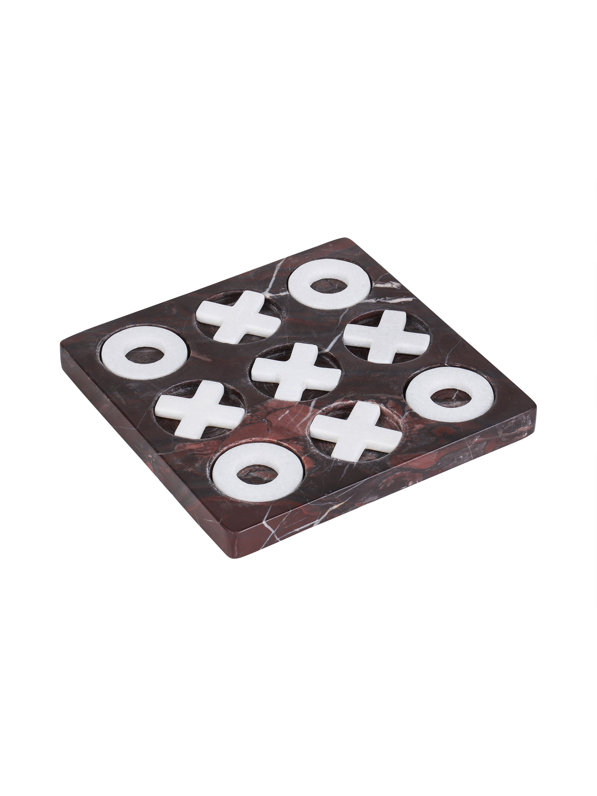 Angled view of a square burgundy marble noughts-and-crosses board with white veining and pale stone pieces sitting in nine circular recesses.