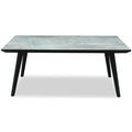 Rectangular dining table viewed from the front and slightly above, showing a pale grey veined top, black perimeter edge and four outward-angled black legs.