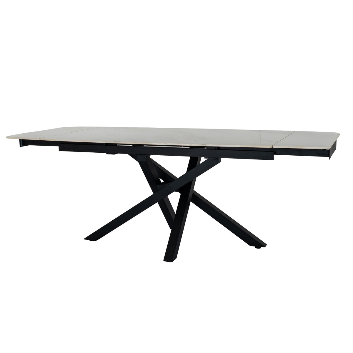 Three-quarter view of the dining table with pale top panels spread along a dark frame above intersecting splayed legs.