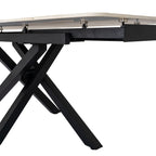 Low close-up beneath the table showing the dark frame, visible supports below the pale panels and intersecting splayed legs.