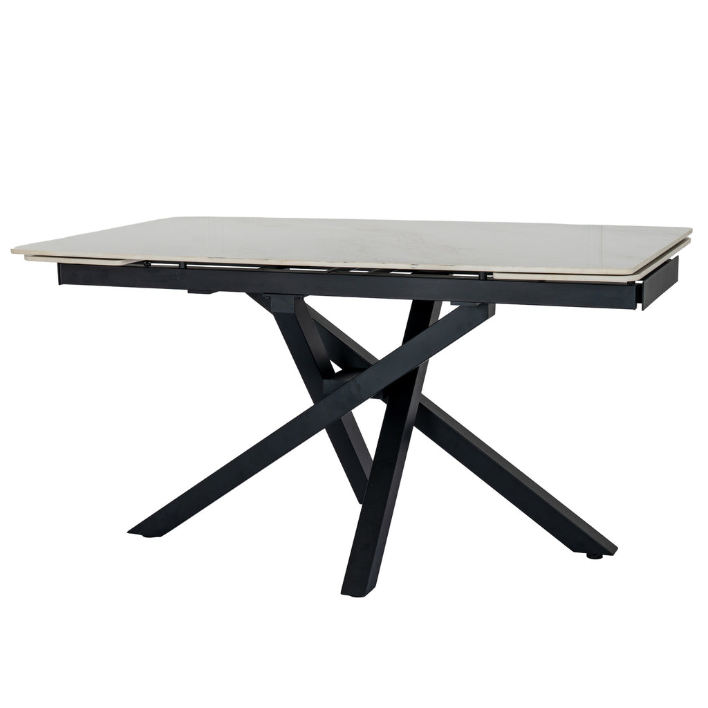 Dining table with pale end panels sitting beneath the main top edges and dark crossed legs below.