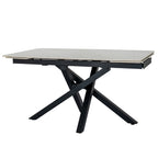 Dining table with pale end panels sitting beneath the main top edges and dark crossed legs below.