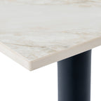 Close-up of the pale tabletop corner, showing fine grey and beige veining along the surface and slim edge above the dark pedestal.