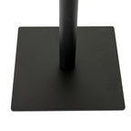 Close-up of the dark cylindrical pedestal meeting the low square base, showing its thin edge and gently rounded corners.