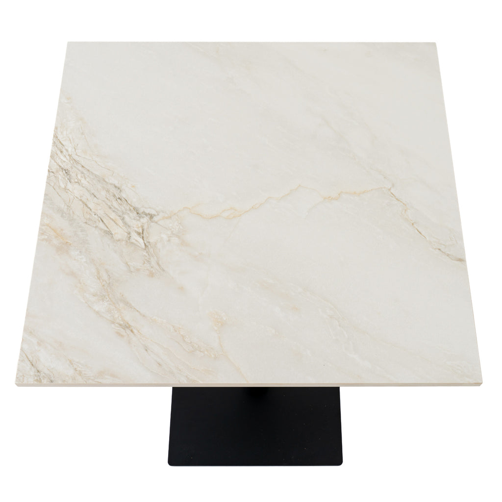 View from above of the square cream-coloured tabletop, with branching grey and beige veins and part of the dark base visible below.