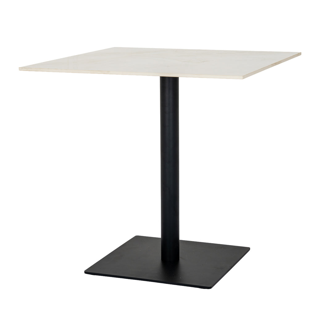 Angled view of a dining table with a pale square top, dark cylindrical pedestal and broad dark square base.