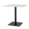 Angled view of a dining table with a pale square top, dark cylindrical pedestal and broad dark square base.