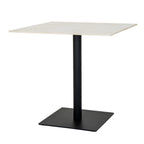 Angled view of a dining table with a pale square top, dark cylindrical pedestal and broad dark square base.