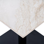 Close-up of the pale tabletop corner showing fine grey and beige veining, a slim edge and part of the dark base below.