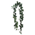 Artificial ivy garland arranged in a long loop against white, with lobed green leaves along thin branching vines.