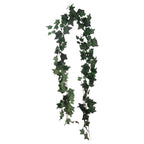 Artificial ivy garland arranged in a long loop against white, with lobed green leaves along thin branching vines.