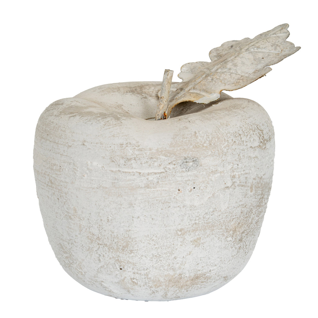 Pale mottled apple ornament viewed from the front, with a rounded lobed body, short stem and leaf angled to the right.