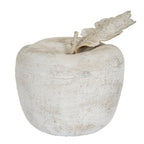 Pale mottled apple ornament viewed from the front, with a rounded lobed body, short stem and leaf angled to the right.