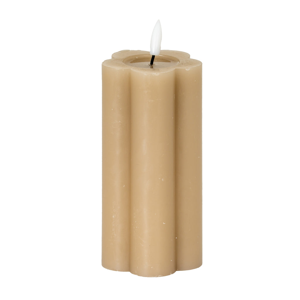 Stone-beige LED pillar candle on a white background, showing rounded vertical lobes, pale surface marks and a white flame-shaped detail above the recessed top.