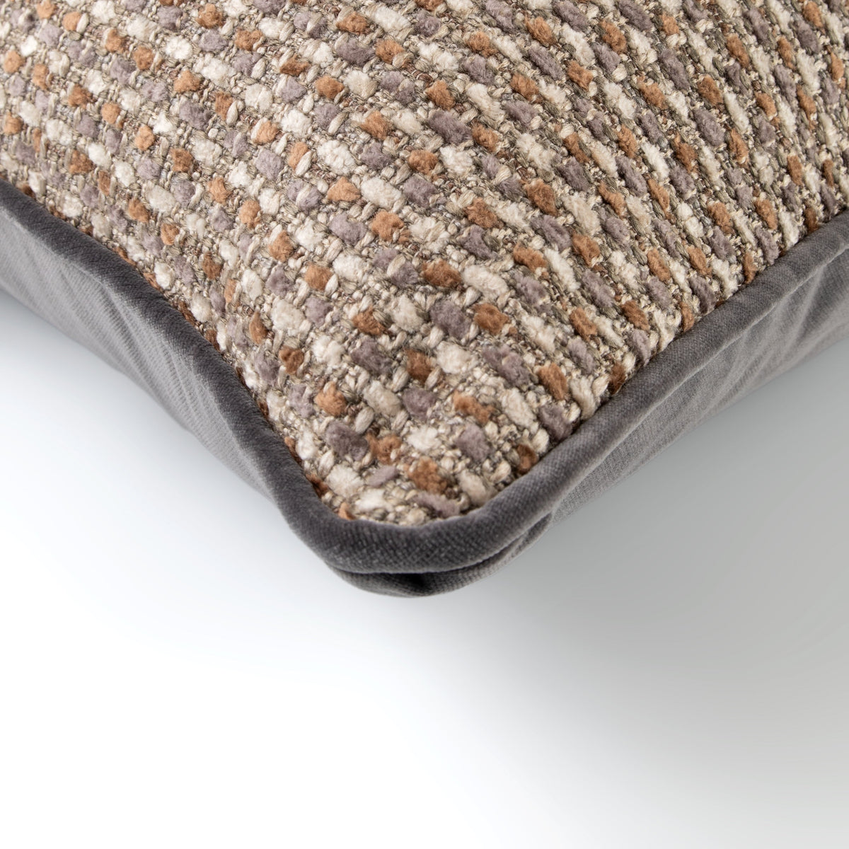 Close-up of the Vireo Cushion showing its brown, grey and cream textured weave with dark velvet border