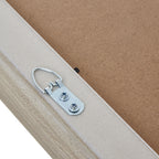 Rear detail of the photo frame with a silver-coloured metal hanging loop secured by two screws beside the tan backing.