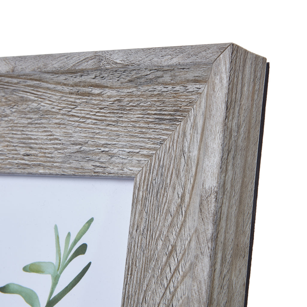 Close-up of the frame's top right mitred corner, showing pale highlights and pronounced grain lines across the wide border.